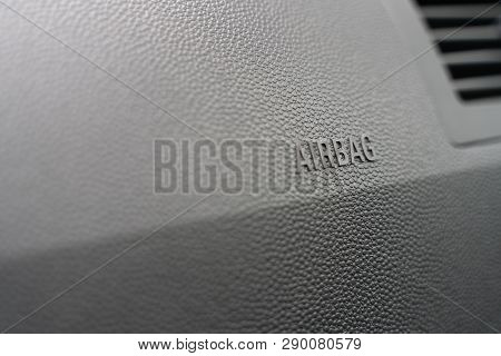 Inscription On The Panel Of The Vehicle Airbag. Background Of Grey Textured Plastic Close-up