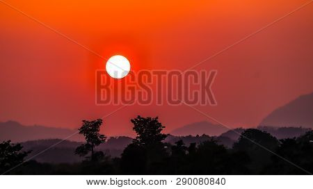 In The Evening The Sun Is Falling Causing The Sky To Become Red Above The Mountains With Very Little