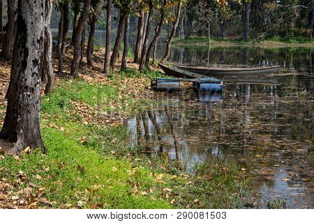 A Half Sunken Boat And A Floating Boat On A Lake In The Summer Season.