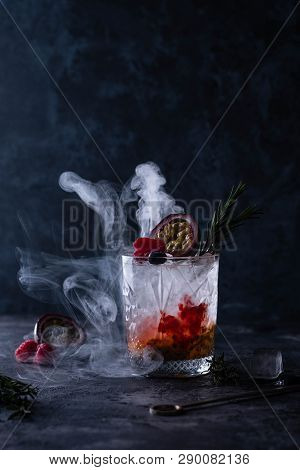 Refreshing With A Glass Of Passion Fruit Cocktail On Black Background.