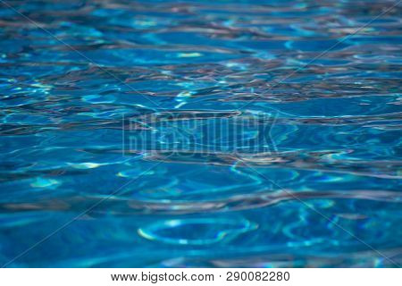 Blurred Water Texture In Summer Pool Close Up.