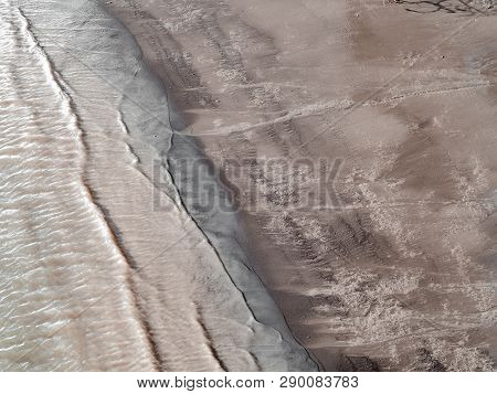 Muddy Water Modestly Waving Into Brisbane River`s Shore
