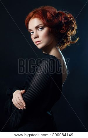Beautiful Woman With Red Hair On A Black Background. Portrait Of A Successful Woman, Pure Skin, Natu