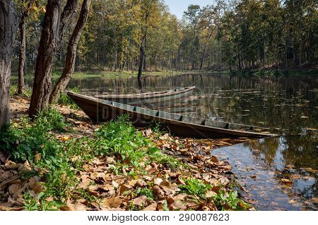 A Half Sunken Boat In A Lake In The Afternoon Sunshine.