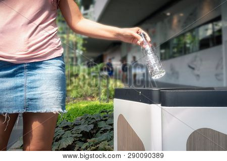 Close-up Woman Hand Is Throwing Plastic A Bottle Of Water Into Garbage Recycle In Department Store, 
