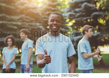 Friendly African-american Millennial Volunteer Showing Thumb Up And Smiling At Camera In Park, Free 