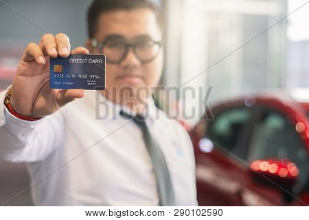 Asian Man Holding Credit Card For Car Blurred Bokeh Background E-shopping Marketing Digital, Consume