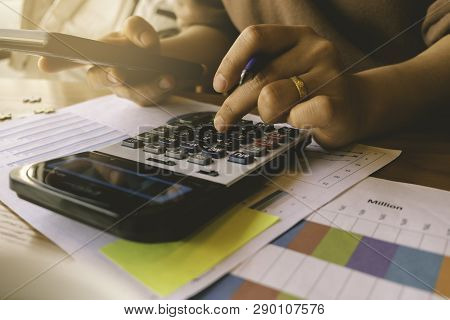 Business Woman Calculating Finance Data At Office.