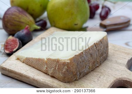 Piece Of French Cheese Tomme De Brebis Made From Sheep Milk Served As Dessert With Fresh Figs And Pe