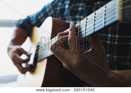 Close Up Men Wearing Blue Plaid Shirts Playing Guitar