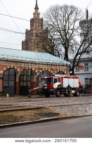 Riga, Latvia - March 16, 2019: Fire Truck Is Being Cleaned - Driver Washes Firefighter Truck At A De