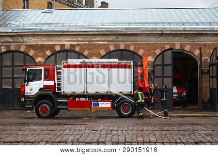 Riga, Latvia - March 16, 2019: Fire Truck Is Being Cleaned - Driver Washes Firefighter Truck At A De