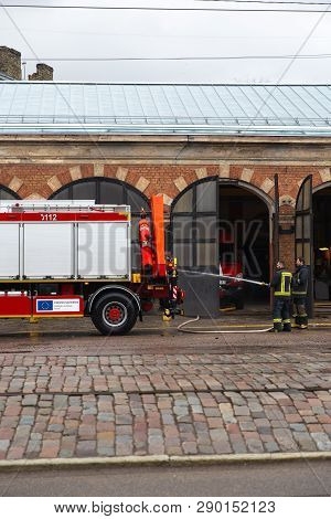 Riga, Latvia - March 16, 2019: Fire Truck Is Being Cleaned - Driver Washes Firefighter Truck At A De