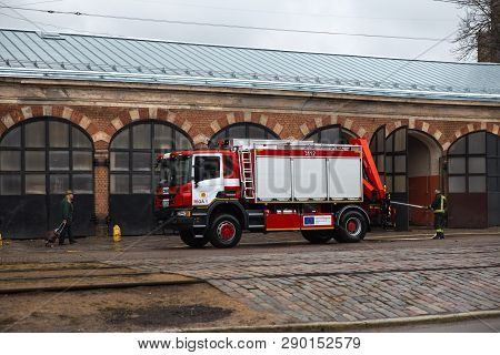 Riga, Latvia - March 16, 2019: Fire Truck Is Being Cleaned - Driver Washes Firefighter Truck At A De