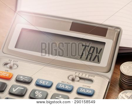 Tax Word On Calculator. Business And Finance Tax Concept For Yearly Tax Time.