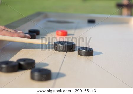 Man Playing Novuss In Outdoors. Novuss Is A National Sport In Latvia Similar To Pocket Billiards Or 