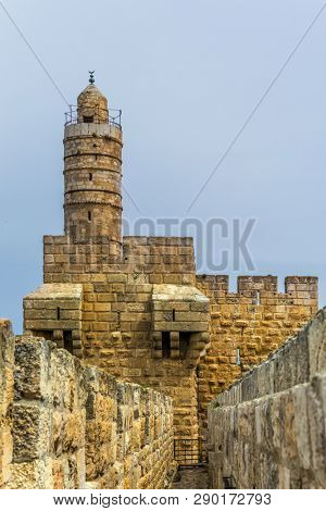 Eternal Jerusalem. Fascinating walk through the ancient walls of Jerusalem. The stone walls sprouted in tufts of grass. The concept of historical and ethnographic torism