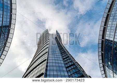 Glass Skyscrapers Of Irregular Shape. Bottom View. Abstract Architectural Detail Of Corporate Buildi