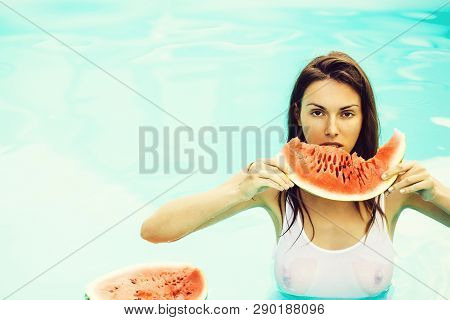 Young Sexy Woman Or Girl With Pretty Face And Long Hair Swimming In Pool With Blue Water In Wet Whit