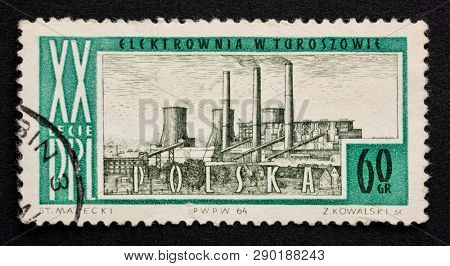 Fort Collins, CO, USA - March 10, 2019: Coal power plant on a vintage canceled post stamp from Poland (1964).