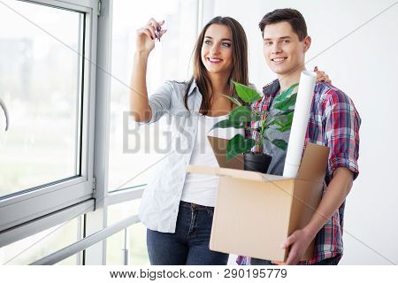 Nnew A Apartment. Happy Couple In Their New Home. Young Couple Hugging Indoors