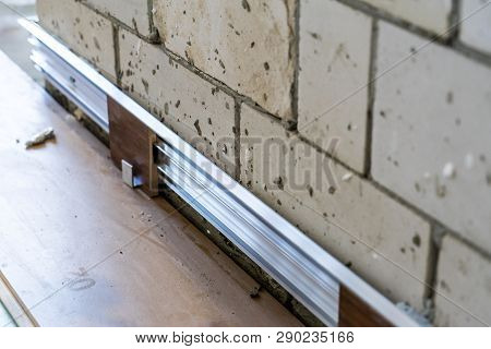 Installation Of Hidden Skirting Board At The Initial Stage Of Finishing Works. Home Repair.
