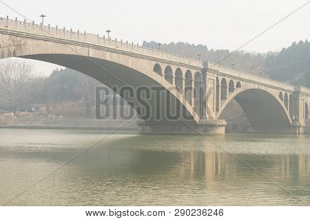 The Walk Way Along And The Bridge With The Chinese Style At The Longmen Grottoes. The Longmen Grotto