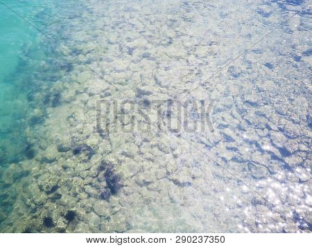 Top View Of Clear Beach Ripple Water With Rock And Black Sea Urchin (arbacia Lixula) On The Sea Floo