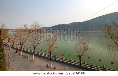 The Walk Way Along And The Bridge With The Chinese Style At The Longmen Grottoes. The Longmen Grotto