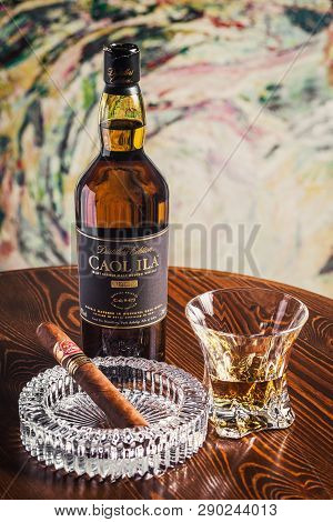 Novosibirsk, Russia - April 07, 2017:  Caol Ila Single Malt Whisky,cigar, Ashtray And A Glass Of Whi