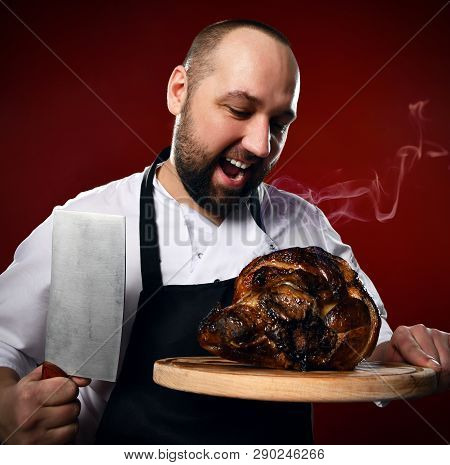Inspired Professional Chef Going To Slice Prepared Steaming Meat Laying On A Wooden Cutting Board Wi