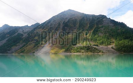 Beautiful Blue Kucherla Lake. Reflection Of Mountains In The Water. Summer Vacation In The Mountains