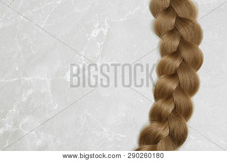 Braided Hair On Grey Background, Top View With Space For Text