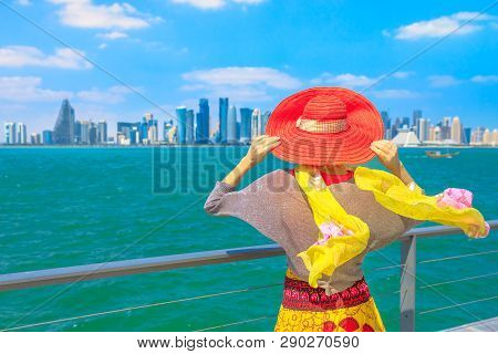 Qatar Travel Concept. Elegant Caucasian Woman Enjoyis The Views Of Doha West Bay. Blonde Tourist At 