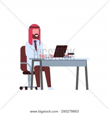 Arab Male Doctor Using Laptop At Workplace Desk Arabic Man In Keffiyeh And Uniform Hospital Medicine