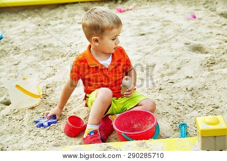 Little Boy On Playground. Playing Child In Sandbox