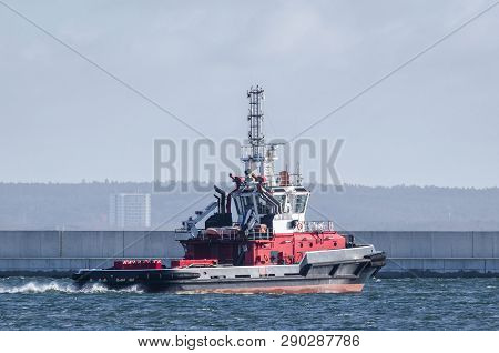 FIREBOAT - Rescue and firefighting ship maneuvers in port by the breakwater