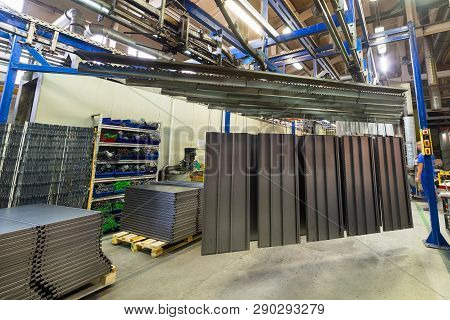 Powder Coating Line. Metal Panels Are Suspended On An Overhead Conveyor Line. Painting Products In A