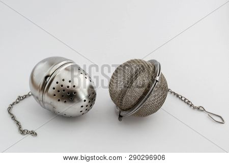 Two Metal Tea Infusers On White Background