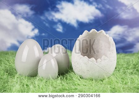 Easter Rabbit In A Shell Of Eggs. Colorful Eggs. Green Grass, Flowers.
