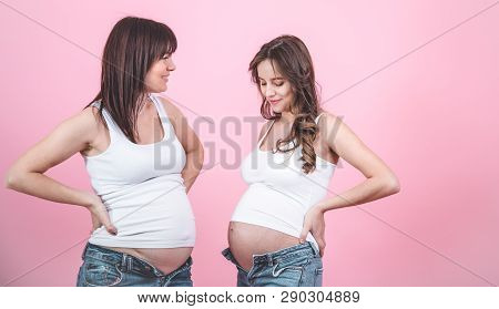 Maternity Concept, Two Pregnant Women With An Open Tummy