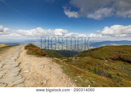 Hiking trail to Mala Babia Gora Mountain from Przelecz Brona Pass in Polish Beskid. High mountains landscape under blue sky with clouds.