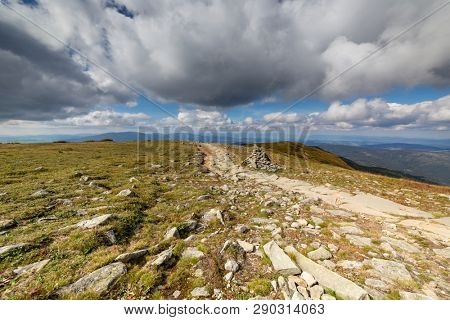 Hiking trail to Mala Babia Gora Mountain from Przelecz Brona Pass in Polish Beskid. High mountains landscape under blue sky with clouds.