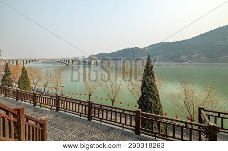The Walk Way Along And The Bridge With The Chinese Style At The Longmen Grottoes. The Longmen Grotto