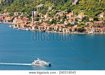 Aerial view of motor boat that run along the water surface leaving a white trail. Montenegro