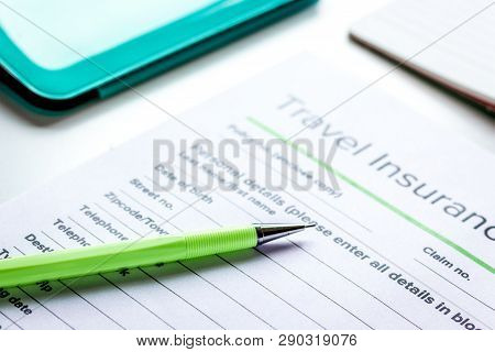 Booking Travel Concept With Insurance On Table Background