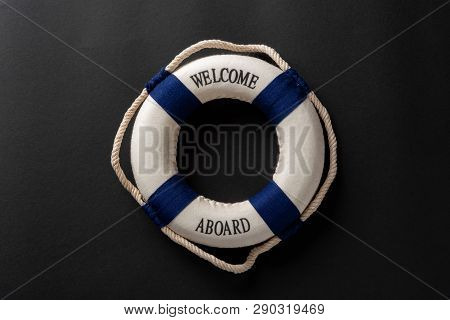 Life Buoy Written With Welcome Aboard On A Dark Background