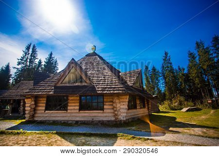 Ethno Old Wooden House In Mountains Forest Village. House Made Of Natural Materials. Old Deserted Wo