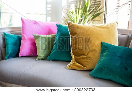 Couch with assorted jewel tone pillows