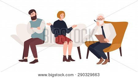 Married Couple On Sofa And Elderly Psychologist, Psychoanalyst Or Psychotherapist Sitting In Front O